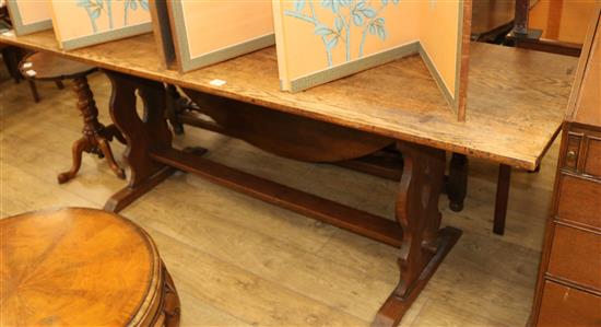 An oak refectory table, with trestle end supports, W.206cm